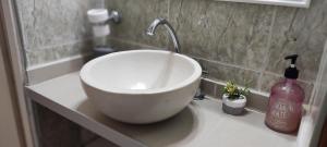 a white bowl sink on a counter in a bathroom at Canciller House Maipu in Maipú