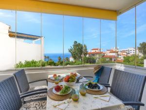 a table with food on a balcony with a view of the ocean at Benalmadena 3 BEACH POOL VIEW, TERRACE, GARDEN in Benalmádena