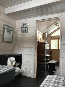 a room with a room with a bed and a table at Villa Tumppu in Jämsä
