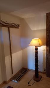a lamp in the corner of a room with a bed at Huis am Berg in Immenstadt im Allgäu