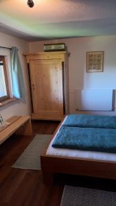 um quarto com uma cama e um armário de madeira em Huis am Berg em Immenstadt im Allgäu