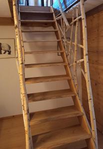 a set of wooden stairs in a room with trees at Huis am Berg in Immenstadt im Allgäu