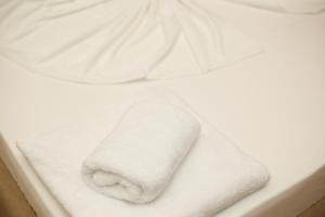 a roll of toilet paper sitting on a white towel at Hotel Amantia in Orikum