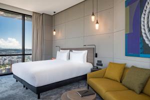 A bed or beds in a room at Pullman Tbilisi Axis Towers