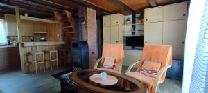 a room with a table and chairs and a kitchen at Chata Skalička in Soběslav