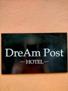 a sign that says dream am post hotel on a wall at DReAM Post Aparthotel in Kraków