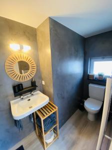 a bathroom with a sink and a toilet at Lovely, renovated appartment, near the beach. in De Haan