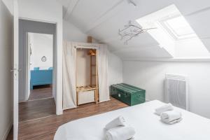Habitación blanca con cama y ventana en Maison Ferry - Welkeys, en Rivedoux-Plage