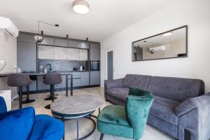 a living room with a couch and a table and chairs at Heaven View Apartment in Rijeka