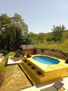 una grande piscina con terrazza e una casa di Bora kuće na reci a Belgrado