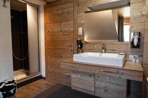 a bathroom with a sink and a mirror at Berghotel TheLounge in Berwang +81 photos