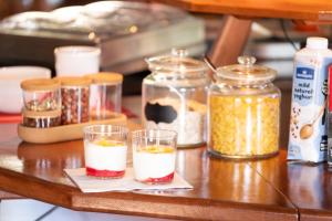 a table with glasses of food and jars of spices at Långforsen Glamping & Lapland Experience in Haparanda