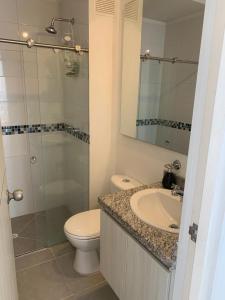 a bathroom with a toilet and a sink and a shower at Aqualina Green Girardot in Girardot