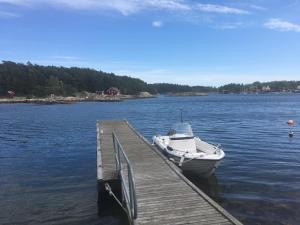 a boat is docked at a dock on a lake at A&M in Nynäshamn