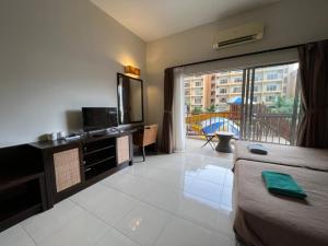 a hotel room with a bed and a balcony at Relax At Gold Coast Morib in Banting