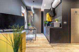 a kitchen with a sink and a counter with a microwave at Ugo Bassi Apartments in Bologna