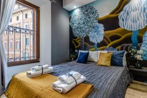 a bedroom with a large bed with towels on it at Ugo Bassi Apartments in Bologna +219 photos