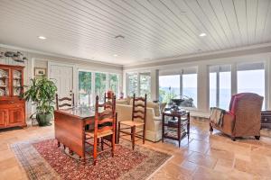 a dining room with a table and chairs and windows at Rising Fawn Home with Expansive Mountain Views! in Rising Fawn