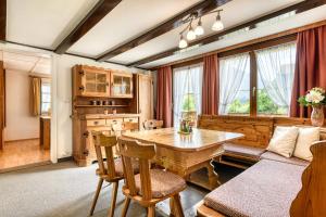 a living room with a wooden table and a couch at Chalet Mariedl in Schruns