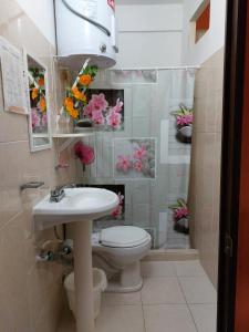 a bathroom with a white sink and a toilet at Alme Hostel in Playa del Carmen