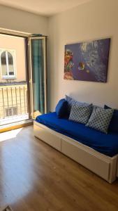 a bedroom with a bed with blue sheets and a window at Sunshine Apartment in Rome