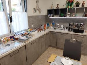 a kitchen with a counter and a table with food at Scilla Resort in Scilla