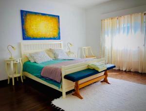 a bedroom with a bed and a painting on the wall at Casa do Trevo in Salir de Porto