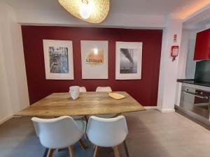 une salle à manger avec une table en bois et des chaises blanches dans l'établissement LXFactory House 39 by Magickey, à Lisbonne