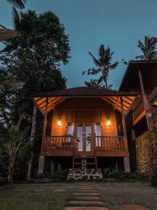 a cabin in the woods at night at Uma d'Nyuh Homestay in Singaraja