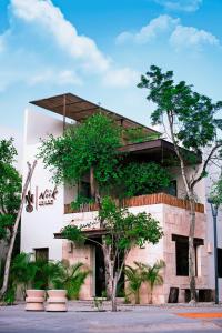 a building with trees in front of it at Niik Tulum in Tulum