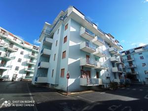 a white apartment building with a stop sign in front of it at Stunning views, 2-Bed Apartment in Scalea in Scalea