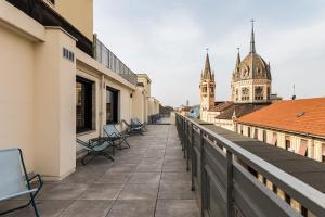 a balcony with chairs and a view of a city at CX Turin Marconi in Turin