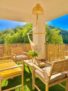 a patio with chairs and a hammock and a fence at Casa Rural Una Ventana a la Sierra in Aracena