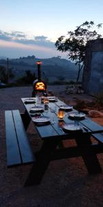 a picnic table with a fireplace in the background at casavistafiore in Montefiore dellʼAso
