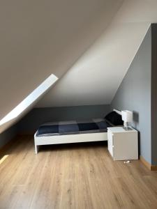 a bedroom with a bed and a white cabinet at Villa Churiana in Camariñas