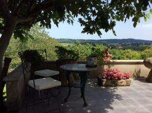 una mesa y sillas en un patio con vistas en La Bergerie, en Gurs