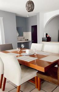a dining room with a wooden table and white chairs at Casa Ragma in Parras de la Fuente