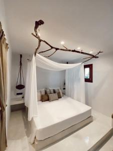 a bedroom with a large white bed in a room at Archo Suites Pythagoreio in Pythagoreio
