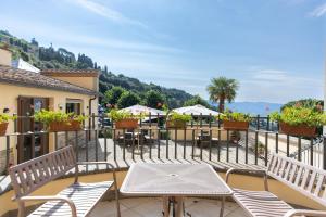 a balcony with tables and chairs on a building at Villa Santa Margherita - B&B in Cortona