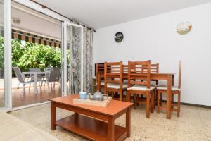 a living room with a table and a dining room at Rentalmar Family Felix con parking incluido in Salou