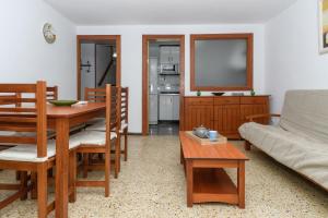 a living room with a table and a couch at Rentalmar Family Felix con parking incluido in Salou +17 photos