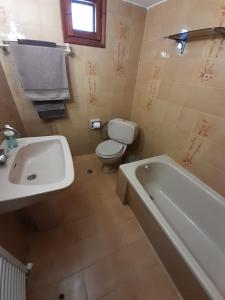 a bathroom with a sink and a toilet and a tub at Adorable 2 floors two bedroom vacation maisonette in Nea Potidaea