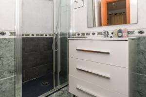 a bathroom with a sink and a shower at Rentalmar Family Felix con parking incluido in Salou