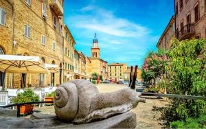 a statue of a snail on a city street at - CASA MANZONI - Luminoso appartamento zona Sferisterio in Macerata