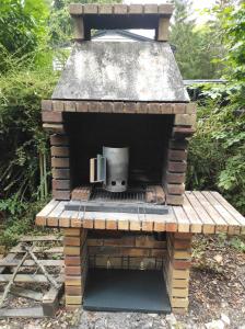 a brick oven with a stove inside of it at Mobile home 6 pers - 45min Paris - RER C - Clim TV - Filéna in Mirgaudon