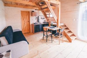 a room with a table and chairs in a tiny house at chaticky.basta in Čakov