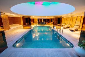 a swimming pool in a hotel with a ceiling at Palmalife Bodrum Resort & Spa in Yalıkavak