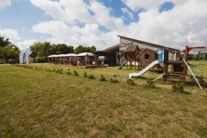 a park with a playground with a slide at Apartamentai Relax Park in Šventoji