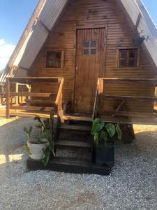 a wooden cabin with stairs in front of it at Colinas do braga chalés in Brumadinho
