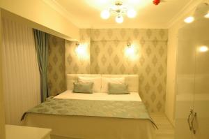 a bedroom with a bed with two pillows at Hotel Iscen in Mustafakemalpaşa